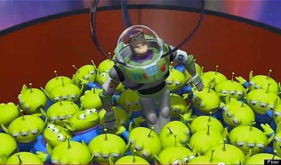 Space Ranger toy surrounded by green aliens in the claw machine